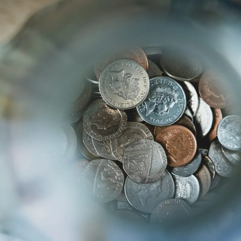 silver round coins on blue round container
